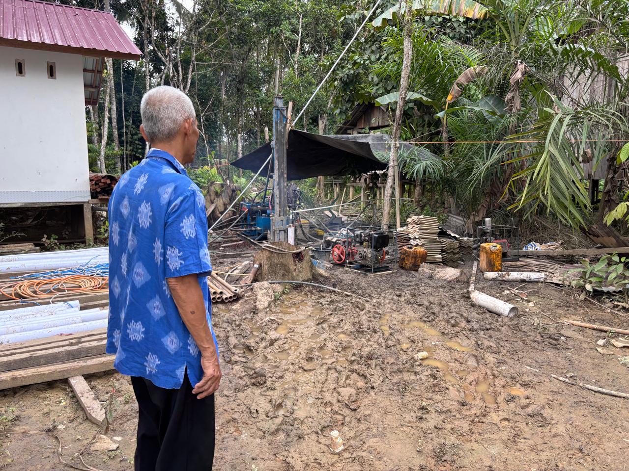 Sibukdin menunjukkan pekerjaan sumur bor di sebelah rumahnya. (Foto: Nofiyatul Chalimah)